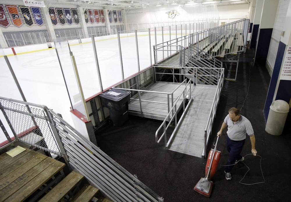A worker cleans around an empty Nashville Predators practice rink in Tennessee. During the NHL lockout, players have had to find other places to practice. (Mark Humphrey/AP)