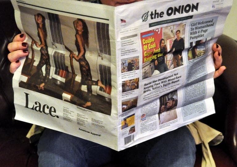 An Onion reader takes in the headlines. (Kevin Harber/Flickr)