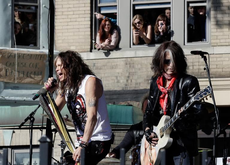 Aerosmith's Steven Tyler, left, and Joe Perry perform a free concert Monday in Boston's Allston neighborhood as fans watch from the apartment building which was Aerosmith's home in the early 1970s. (Elise Amendola/AP)