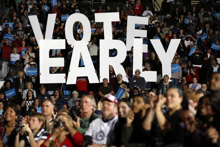 A &quot;Vote Early&quot; sign is displayed at an Obama campaign rally Oct. 29 in Ohio. (Matt Rourke/AP)