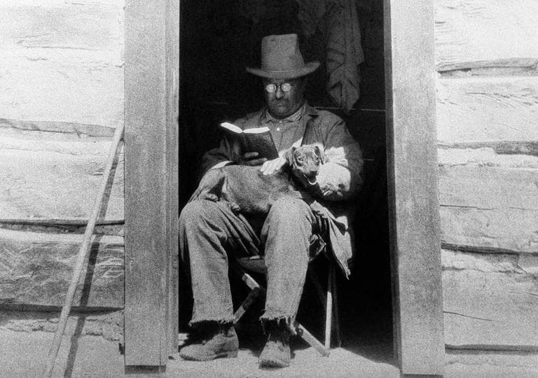 President Theodore Roosevelt, considered one of the most well-read American politicians of all time, reads a book with his dog Skij on his lap in Colorado in April 1905. (AP)