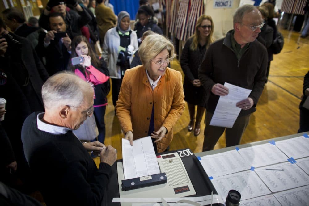Then-U.S. Senate candidate Elizabeth Warren and her husband Bruce Mann vote at a school in Cambridge on Election Day in 2012. A new study pegs Cambridge as the most liberal mid-size municipality in Massachusetts. (Dominick Reuter/WBUR)