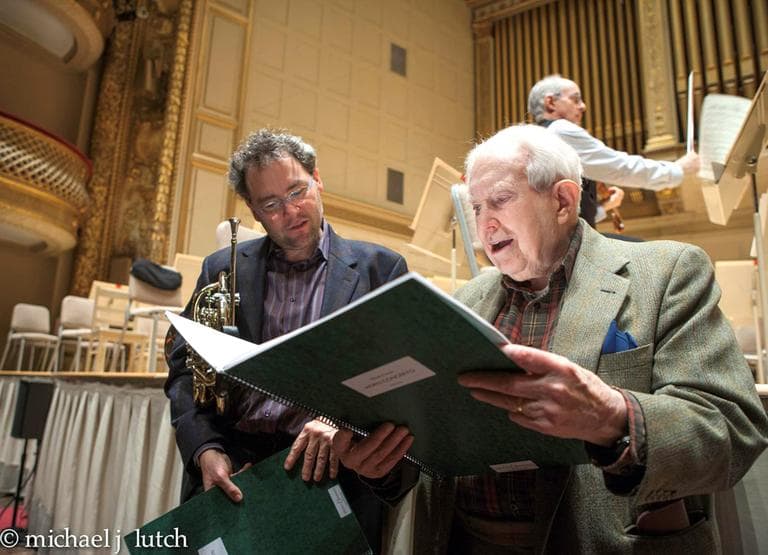 Elliott Carter reviews his composition, &quot;Horn Concerto&quot; with Boston Symphony Orchestra principal horn player James Sommerville during a rehearsal at Symphony Hall Boston. (Michael Lutch/H&amp;N listener)