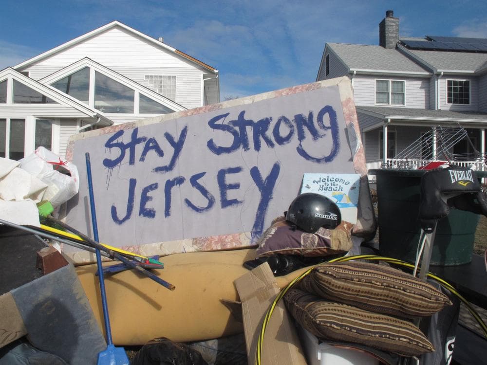 Residents of a flood-wrecked home in Point Pleasant Beach N.J. offer encouragement to fellow Superstorm Sandy victims as a nor'easter is was due to hit the shore Wednesday. (AP Photo/Wayne Parry)