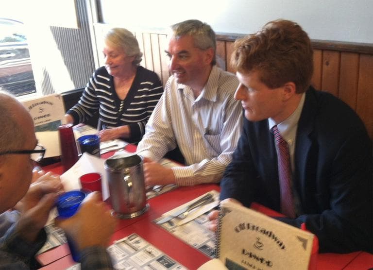 U.S. Rep.-elect Joseph Kennedy III, right, talks to supporters at a Taunton diner Friday. (Fred Thys/WBUR)