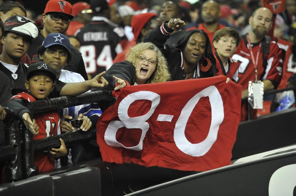 Falcons fans celebrate after the Falcons defeated the Dallas Cowboys last Sunday. The Falcons are 8-0 this season. (Rich Addicks/AP)