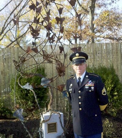 Staff Sgt. William Kleinedler and his sculpture, &quot;Integro,&quot; in the new Fisher House Healing Garden at the VA Medical Center in West Roxbury (Lynn Jolicoeur/WBUR)