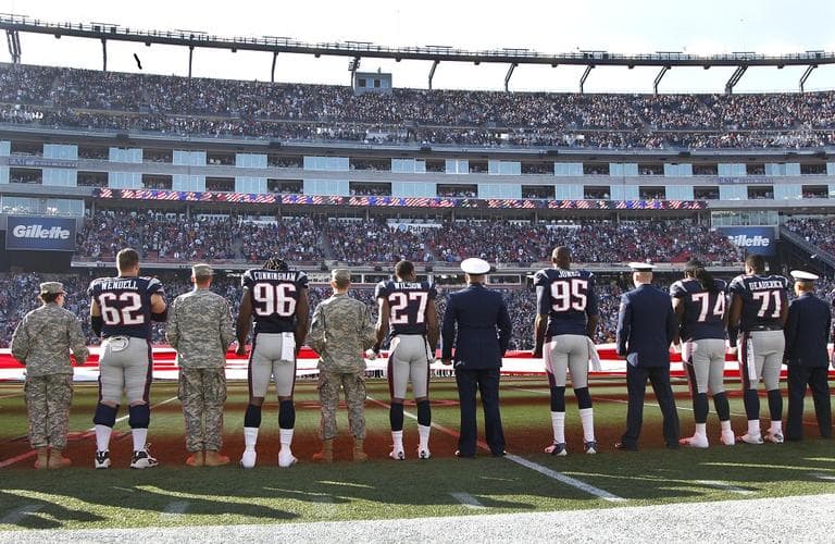 New England Patriots players line up with service members for the national anthem at Gillette Stadium on Sunday, Nov. 11, 2012. (AP/Elise Amendola)
