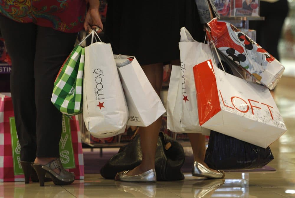 Shoppers stop to look at a display while shopping at Dadeland Mall, in Miami on November 25, 2011. (Lynne Sladky/AP)