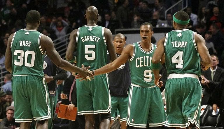 Celtics' Rajon Rondo (9) celebrates with teammates Brandon Bass and Jason Terry in Chicago. The Celtics beat the Bulls, 101-95. (Charles Rex Arbogast/AP)