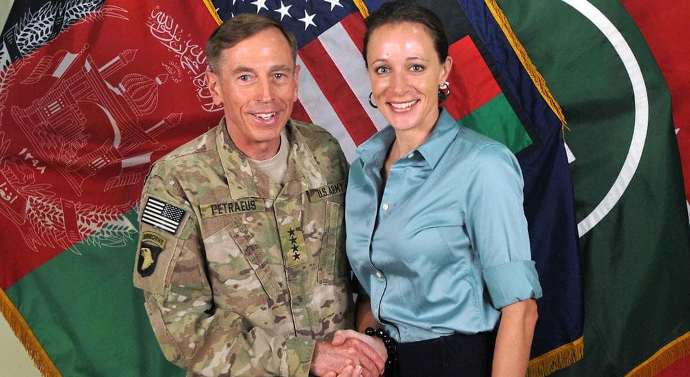 Former Commander of International Security Assistance Force and U.S. Forces-Afghanistan Gen. Davis Petraeus shaking hands with Paula Broadwell, co-author of his biography, &quot;All In: The Education of General David Petraeus.&quot; (ISAF/AP File)