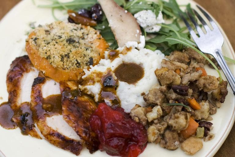 A Thanksgiving dinner plate of cider brined turkey with sage gravy, peach cranberry sauce, sour cream and chive mashed potatoes, sausage pecan stuffing, arugula pear salad with pomegranate vinaigrette and goat cheese and herb crusted sweet potatoes. (AP)