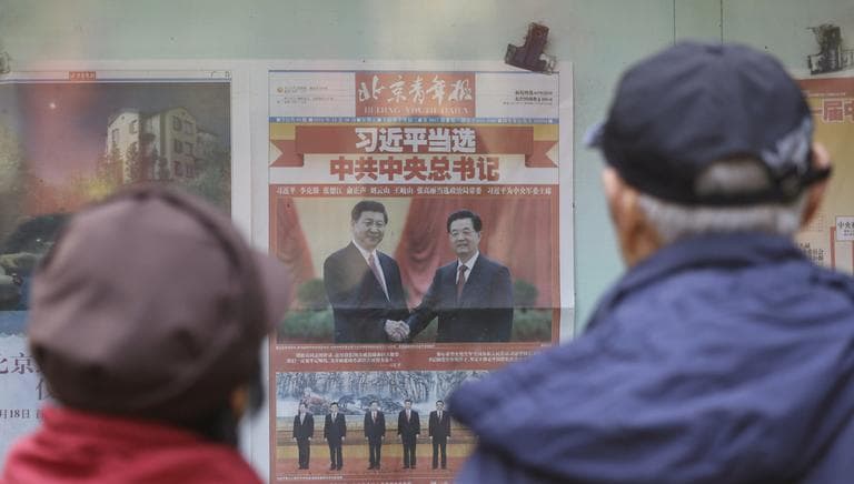A Chinese couple look at a newspaper carrying photos of new General Secretary of Communist Party of China Xi Jinping, top left, shaking hands with his predecessor Hu Jintao, top right, and Xi and other members of the party leadership in Beijing, China, Friday Nov. 16, 2012. Long-anointed successor Xi assumes the leadership of China at a time when the ruling Communist Party is confronting slower economic growth, a public clamor to end corruption and demands for change that threaten its hold on power. (AP)