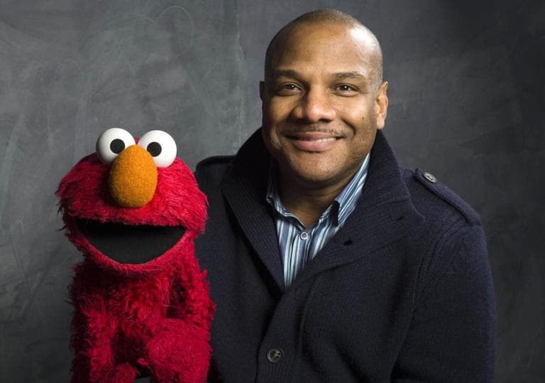 A 2011 photo of Elmo puppeteer Kevin Clash with the Sesame Street Muppet. (Victoria Will/AP)