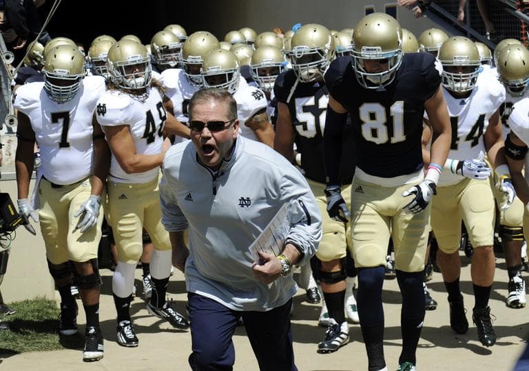 In this April 21, 2012, photo, Notre Dame coach Brian Kelly leads his team onto the field for their spring NCAA college football game in South Bend, Ind. (Joe Raymond/AP)