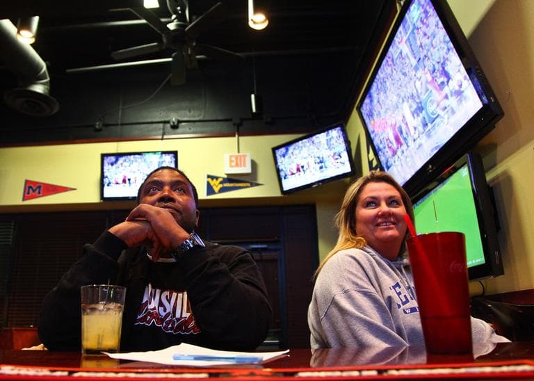Damon Harris and Debbie Bailey are a couple divided. He's a Cardinal fan. She loves the Wildcats. On a Friday night, they watch UK stomp Lafayette College. (Anne Marshall/Only A Game)