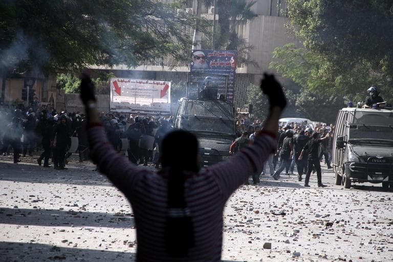 Egyptian security forces, background, clash with protesters near Tahrir Square in Cairo, Egypt on Sunday. (Ahmed Gomaa/AP)