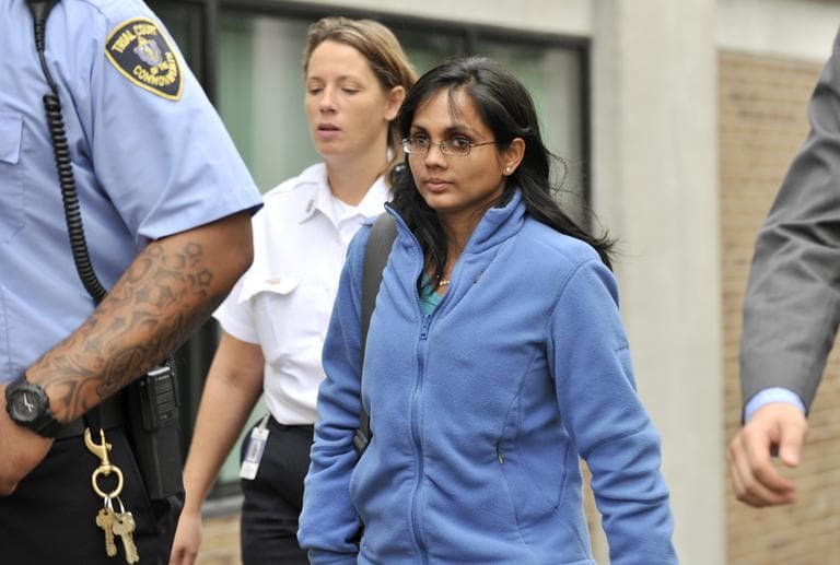 Annie Dookhan, center, leaves a Boston courthouse escorted by court officers and her lawyer on Oct 10. (Josh Reynolds/AP File)