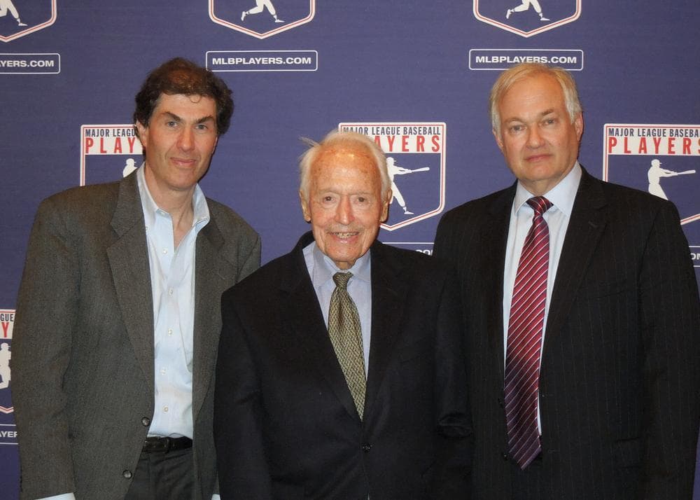 Marvin Miller, center, the former head of the MLB Players' Association, with current executives of the MLBPA and NHLPA in April 2012. (Ashton Ramsburg/AP)