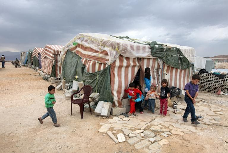 Syrian refugees children stand in front of their tents at a refugee camp last month in Arsal, a Sunni Muslim town eastern Lebanon near the Syrian border, that has become a safe haven for war-weary Syrian rebels and hundreds of refugee families. (Bilal Hussein/AP)