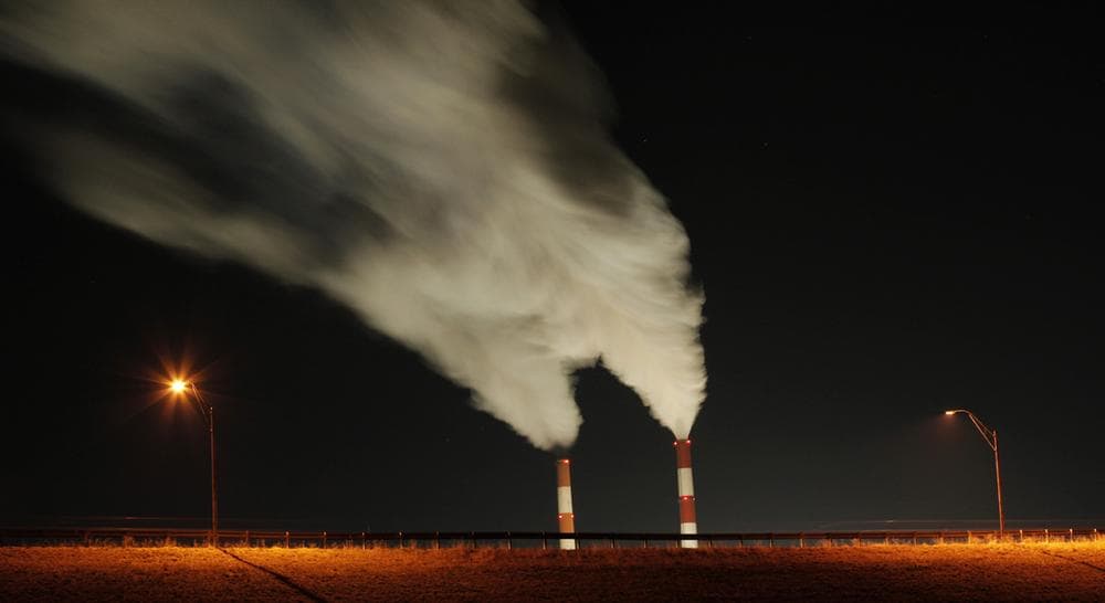 In this Jan. 19, 2012 file photo, smoke rises in this time exposure image from the stacks of the La Cygne Generating Station coal-fired power plant in La Cygne, Kan. Federal records show that this year the nation’s weather has been hotter and more extreme than ever. (Charlie Riedel/AP, file)