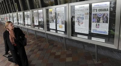 Elieen Muirragui of Prince William County, Va., looks at the newspaper front pages posted outside the Newseum in Washington, Wednesday, Nov. 7, 2012. The majority of newspapers featured photos of President Barack Obama who successfully defeated former Massachusetts Gov. Mitt Romney in the presidential election. (Susan Walsh/AP)