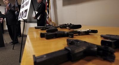 Los Angeles Police Chief William Bratton speaks at a news conference next to several weapons, part of a haul that included more than 1,200 pounds of marijuana found in an apartment building in Los Angeles, Friday, April 7, 2006. (Nick Ut/AP)