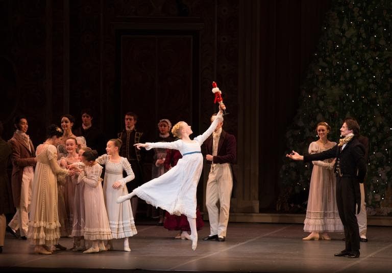Clara  (Chelsea Perry) treasures the Nutcracker, a present from her uncle, the magician Drosselmeier (right). Photo courtesy of Boston Ballet.