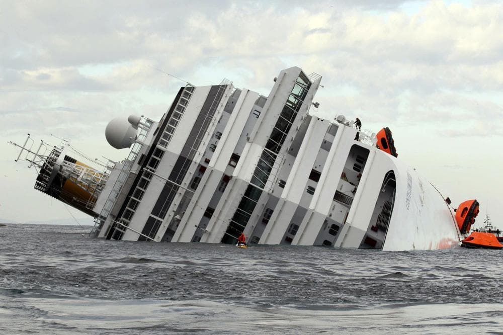 The luxury cruise ship CostaConcordia lies on its side after it ran aground off the tiny Tuscan island of Giglio, Italy, Sunday, Jan. 15, 2012. (AP Photo/Andrea Sinibaldi, Lapresse)