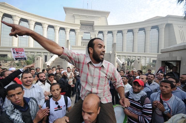 A demonstrator chants slogans as several thousand supporters of Islamist President Mohammed Morsi surrounded the Supreme Constitutional Court on Sunday to prevent the judges from entering and ruling on the legitimacy of the nation's Islamist-dominated constituent assembly. (Ahmad Hammad/AP)