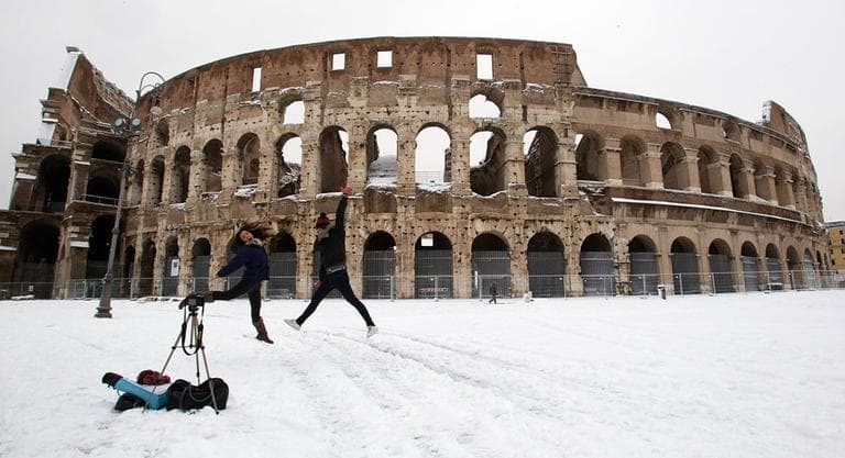 Two girls take a self-timer photo in front of a snow surrounded ancient Colosseum, in Rome Saturday, Feb. 4, 2012. A rare snowfall blanketed Rome on Friday, forcing the closure of the Colosseum over fears tourists would slip on the icy ruins, and leaving buses struggling to climb the city's slushy hills. (AP Photo/Andrew Medichini)