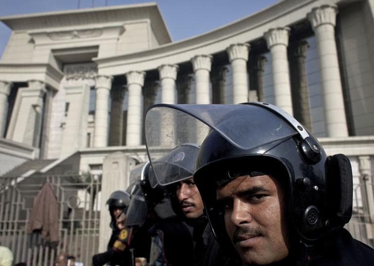 Riot policemen stand guard in front of Egypt's top court during a protest for supporters of Egyptian President Mohammed Morsi in Cairo, Egypt, Monday, Dec. 3, 2012. (Nasser Nasser/AP)