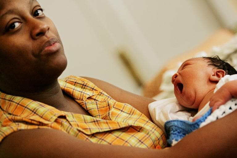 Hurricane Katrina refugee Angela Davis cradles her newborn son Taji at a special church shelter in Baton Rouge, La. in 2010. Taji was born the day after the storm. (Haraz N. Ghanbari/AP)