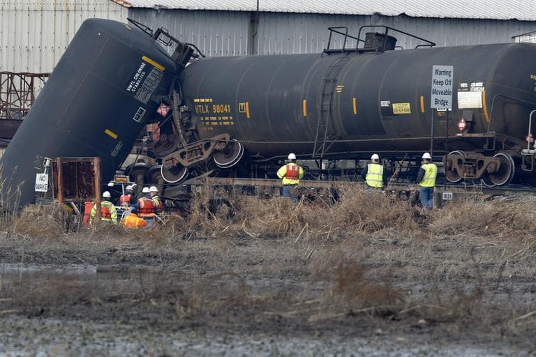 Officials examine the area around a derailed freight train tank car in Paulsboro, N.J. on Nov. 30, 2012. (Mel Evans/AP)