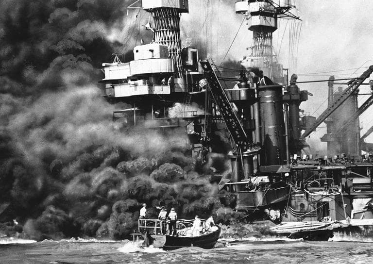 In this photo provided by the U.S. Navy, a Navy launch pulls up to the blazing USS West Virginia to rescue a sailor, Dec. 7, 1941, during the attack on Pearl Harbor (U.S. Navy/AP)