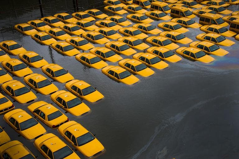 A parking lot full of yellow cabs is flooded as a result of superstorm Sandy in Hoboken, NJ. Oct. 30, 2012. (AP Photo/Charles Sykes, File)