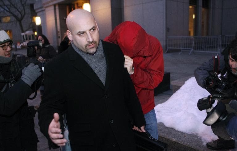 Hiding his face beneath a red hooded jacket, hedge fund portfolio manager Donald Longueuil leaves federal court Tuesday, Feb. 8, 2011 in New York. Longueuil is facing obstruction of justice and conspiracy charges stemming from an insider trading probe by federal authorities. (AP)