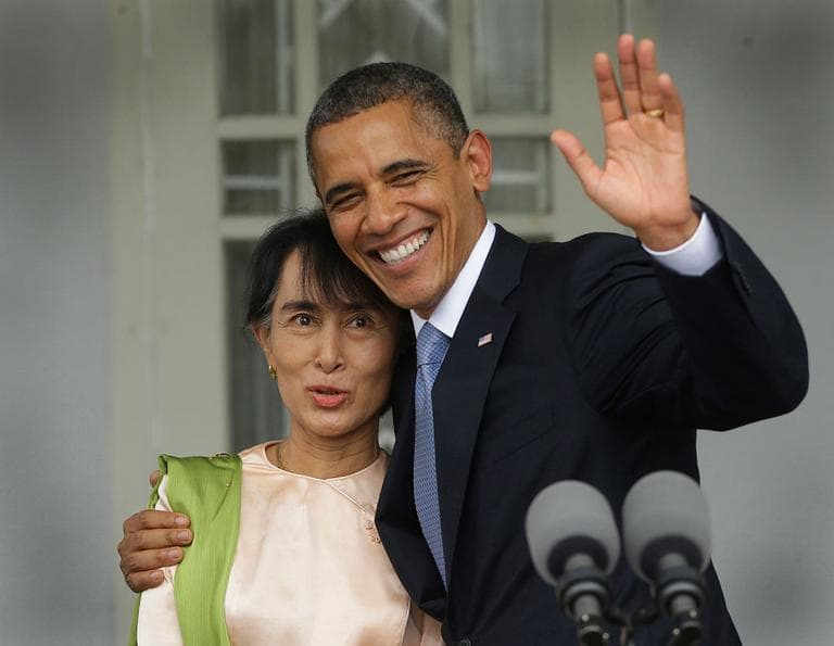U.S. President Barack Obama, right, waves as he embraces Myanmar democracy activist Aung San Suu Kyi after addressing members of the media at Suu Kyi's residence in Yangon, Myanmar, Nov. 19, 2012. Obama became the first U.S. president to visit the Asian nation also known as Burma. (AP Photo/Pablo Martinez Monsivais)