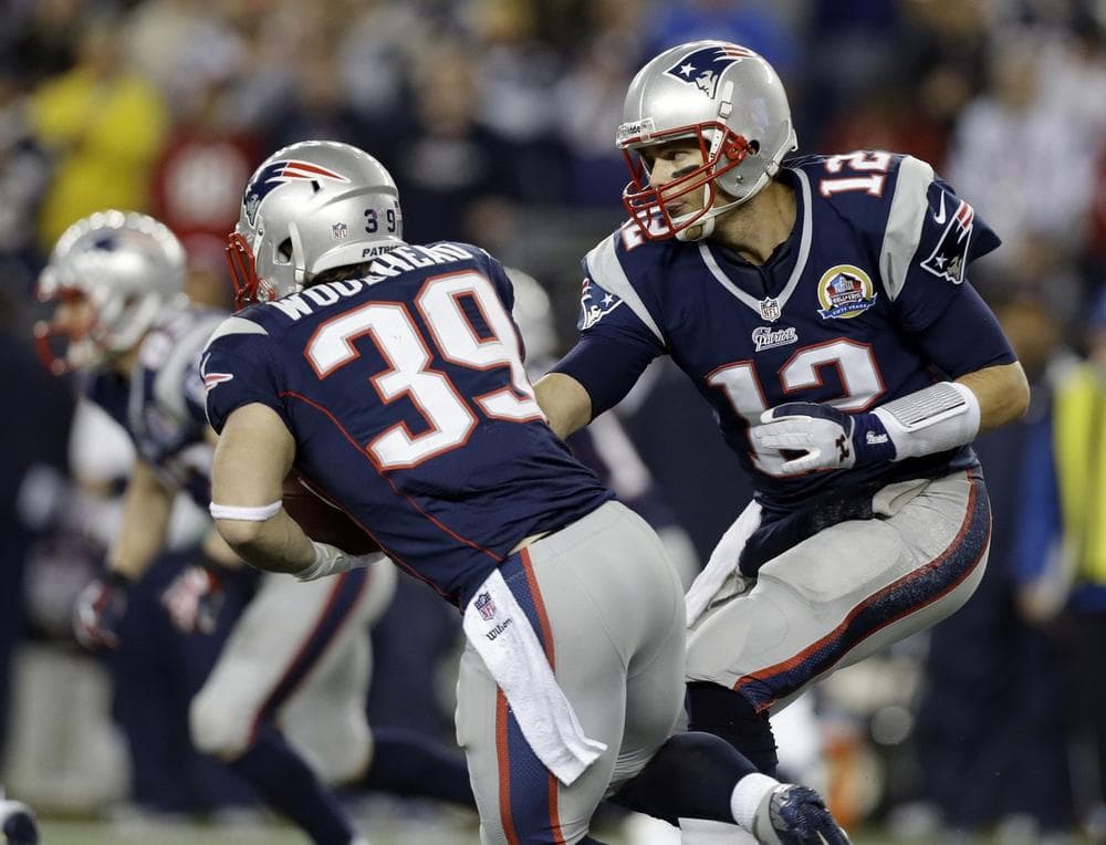 Patriots quarterback Tom Brady hands off to running back Danny Woodhead (39) during the second quarter of Monday's game. (Elise Amendola/AP)