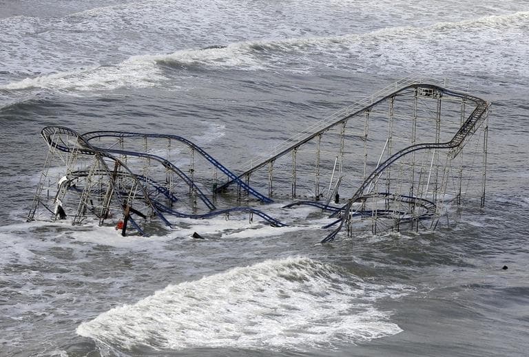 In this Wednesday, Oct. 31, 2012 file photo, waves wash over a roller coaster from a Seaside Heights, N.J. amusement park that fell in the Atlantic Ocean during superstorm Sandy. (AP/Mike Groll)