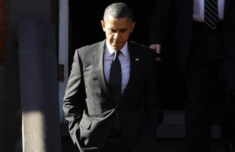 President Barack Obama walks out of Blair House in Washington, Thursday, Dec. 13, 2012, before crossing Pennsylvania Avenue and returning to the White House after attending a holiday party for the National Security Council. (AP)