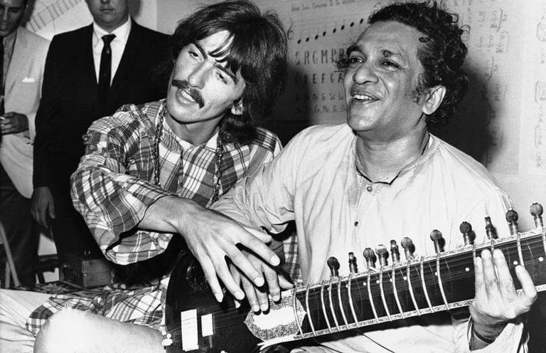 In this Aug. 3, 1967 file photo, George Harrison, of the Beatles, left, sits cross-legged with his musical mentor, Ravi Shankar of India, in Los Angeles, as Harrison explains to newsmen that Shankar is teaching him to play the sitar. Shankar, the sitar virtuoso who became a hippie musical icon of the 1960s after hobnobbing with the Beatles and who introduced traditional Indian ragas to Western audiences over an eight-decade career, died Tuesday, Dec. 11, 2012. He was 92.  (AP)