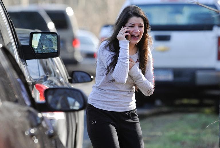 A woman waits to hear about her sister, a teacher, following a shooting at the Sandy Hook Elementary School in Newtown, Conn., Friday. (Jessica Hill/AP)