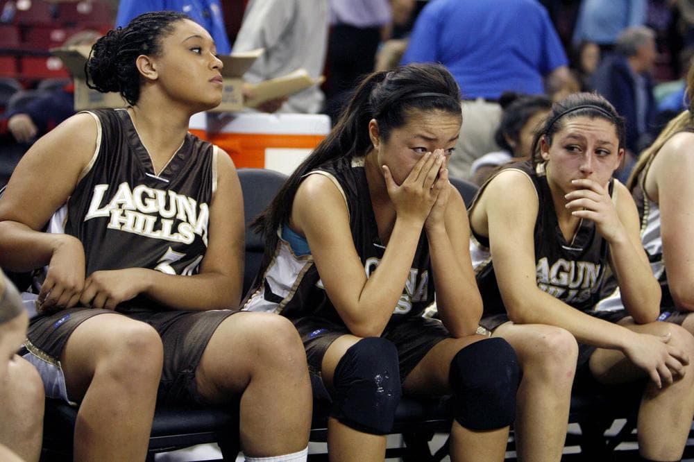 Players from Laguna Hills High School sit on the bench after loosing to Bishop O' Dowd of Oakland in a state high school basketball championship game in California. (Steve Yeater/AP)