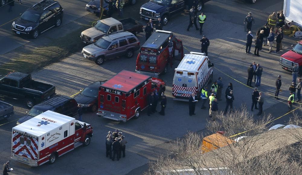 Authorities organize in Newtown, Conn., where a gunman opened fire inside an elementary school in a shooting that left 27 people dead, including 20 children. (Julio Cortez/AP)