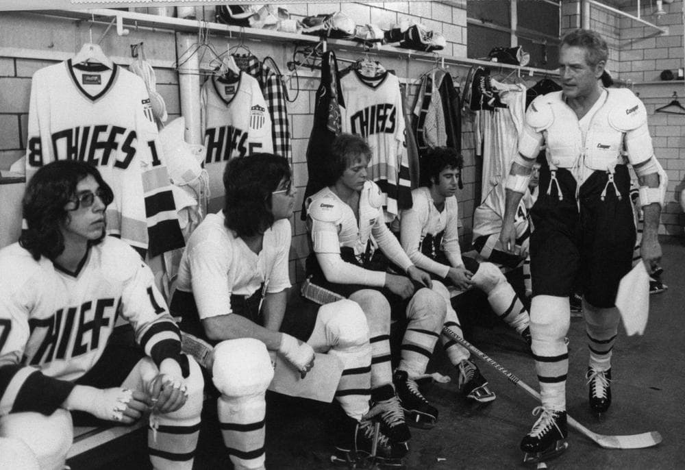 Paul Newman, (r) in the role of Charlestown Chiefs coach Reggie Dunlop, addresses his team, including two of the three Hanson brothers (in glasses). This year marks the 35th anniversary of 'Slap Shot'. (AP)