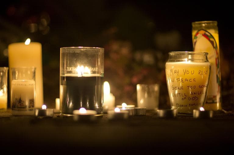 A message is seen on a candle outside the St. Rose of Lima Roman Catholic Church, Saturday, Dec. 15, 2012, in Newtown, Conn. (David Goldman/AP)
