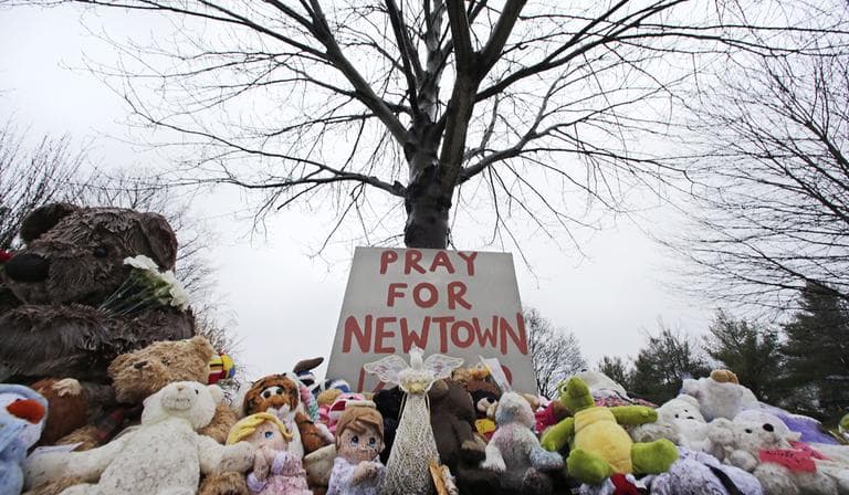 Stuffed animals and a sign calling for prayer rest at the base of a tree near the Newtown VIllage Cemetery in Newtown, Conn., Monday, Dec. 17, 2012. Six-year-old student Jack Pinto, who was killed Friday when a gunman opened fire inside the Sandy Hook Elementary School, is scheduled to be buried at the cemetery Monday afternoon. (AP)
