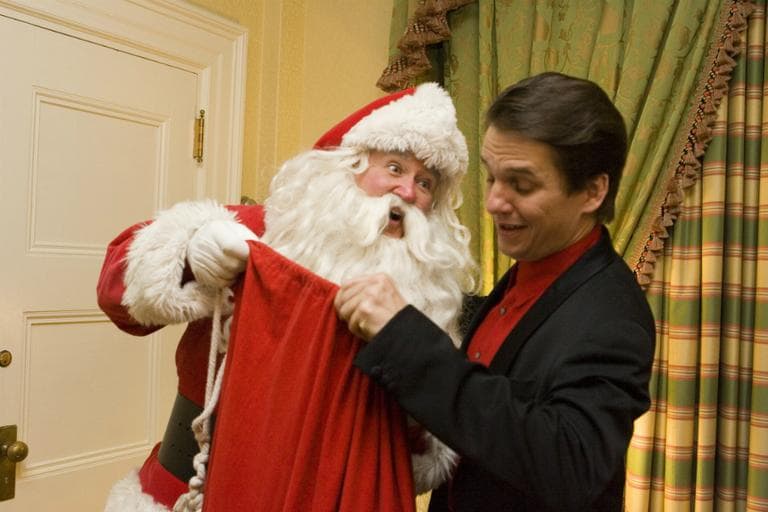 In this photo provided by the Boston Symphony Orchestra, Boston Pops Conductor Keith Lockhart and Santa Claus relax backstage, during intermission of the Holiday Pops opening night concert Friday night, Dec. 9, 2005, in Boston. (Michael J. Lutch/Boston Symphony Orchestra, AP)