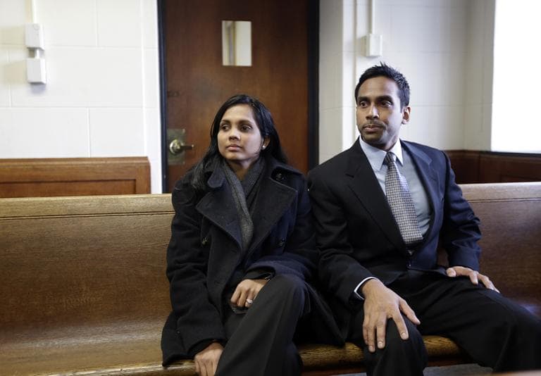 Annie Dookhan, left, sits with an unidentified man, right, in Suffolk Superior Court moments before her arraignment Thursday (Steven Senne/AP/Pool)